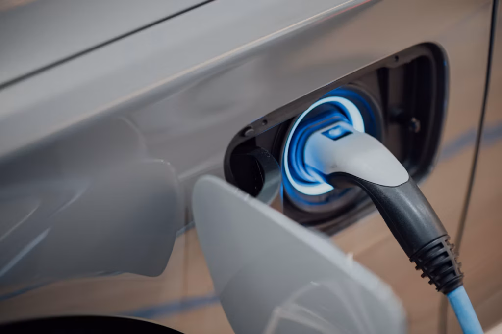 Electric vehicle connected to a charging cable, illustrating the increased electrical demand placed on modern homes.